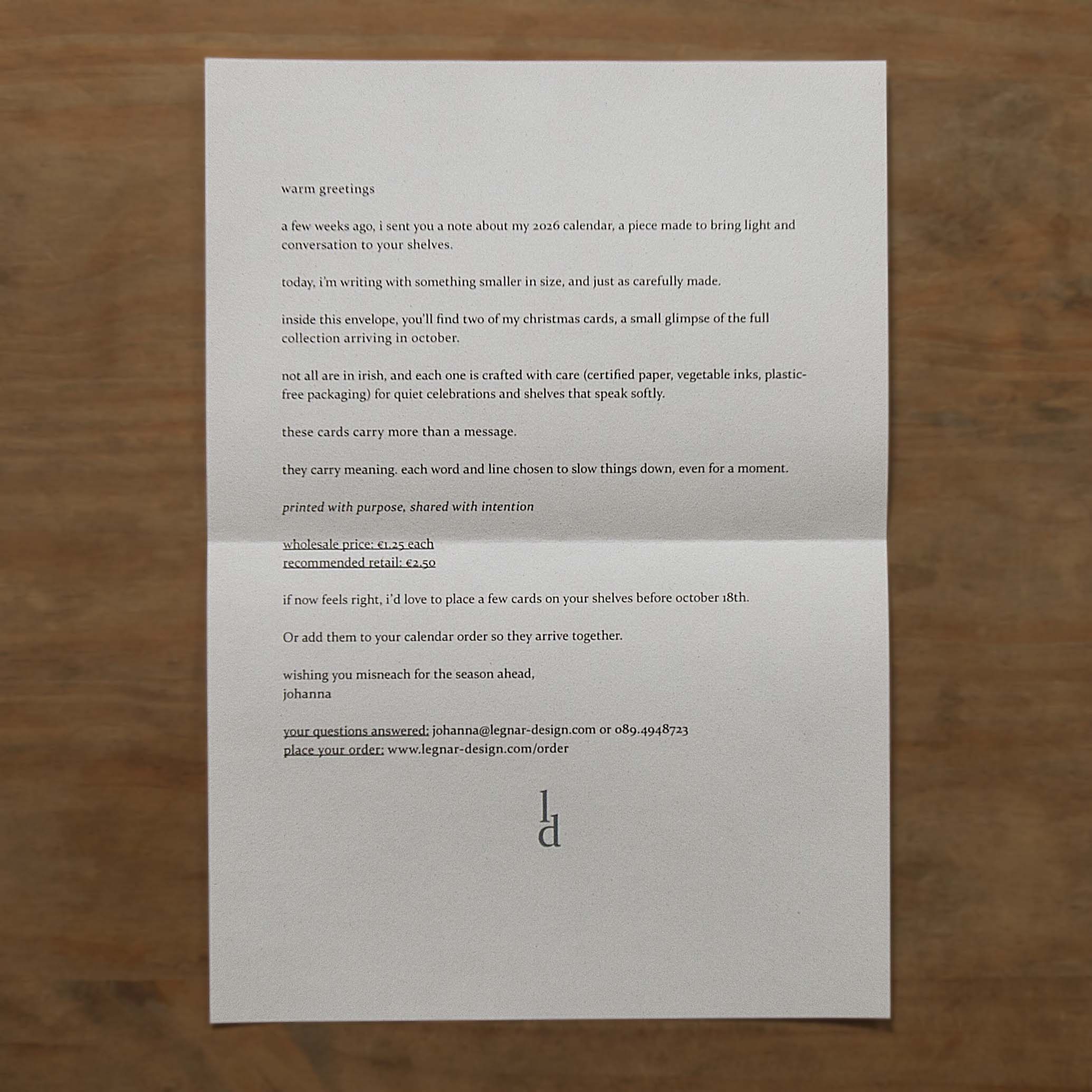 the image shows a printed letter on a wooden desk.